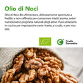 Testo descrittivo dell'Olio di Noci Bio, spremuto a freddo e non raffinato, su cumulo di gherigli di noce